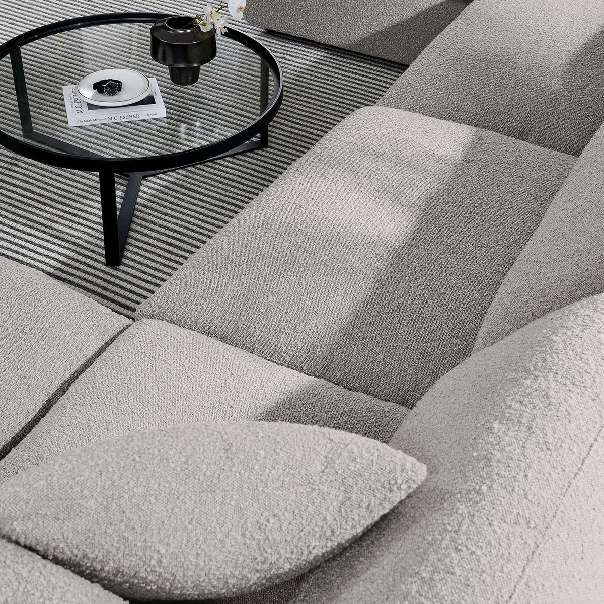 Boucle upholstery and plush cushions invite relaxed lounging on the light gray Commix sectional || EEI-6366-LGR || detail_room