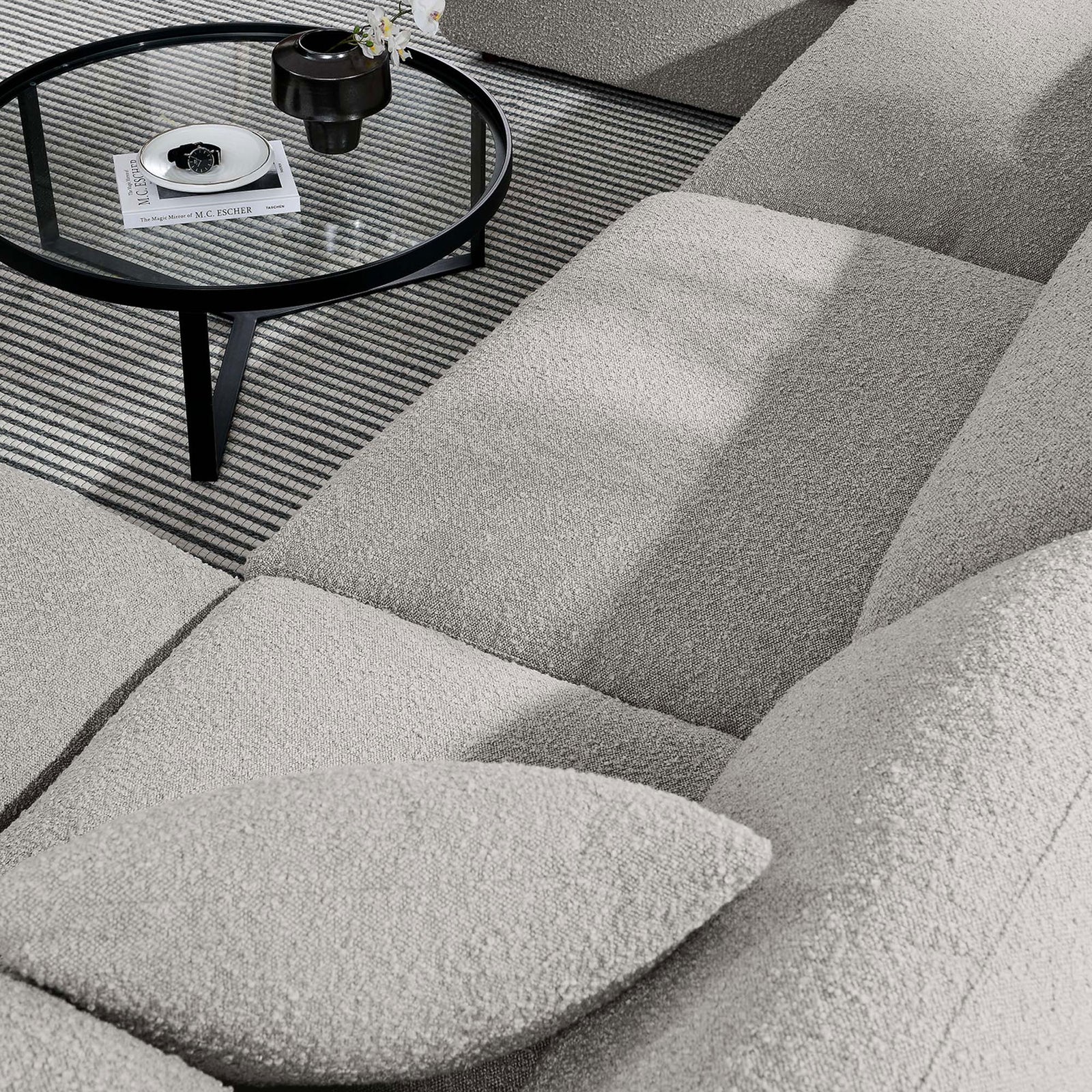 Boucle upholstery and plush cushions invite relaxed lounging on the light gray Commix sectional || EEI-6366-LGR || detail_room