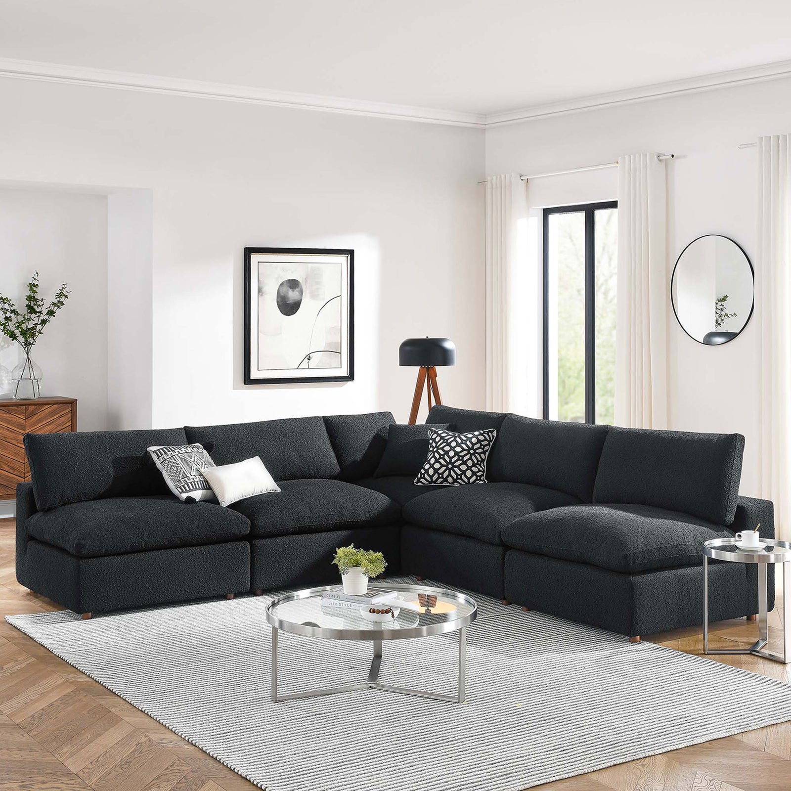 Black boucle sectional sofa anchoring a spacious living room with light walls, wood floors, and modern decor || EEI-6367-BLK || front_angle_room