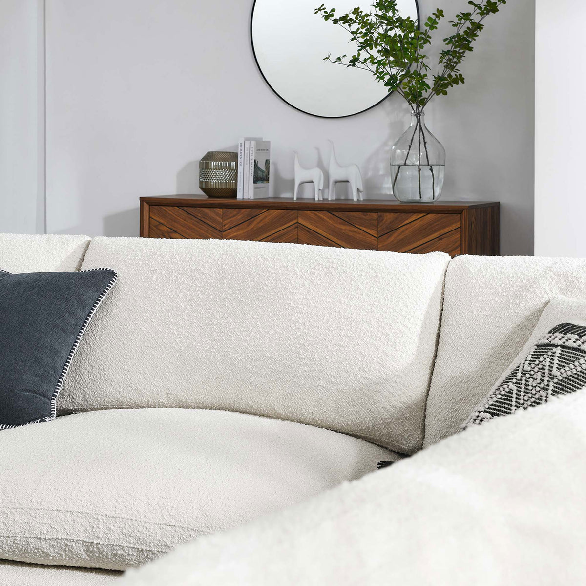 Detail of the ivory boucle sectional showing the cozy corner and inviting seat depth || EEI-6367-IVO || detail_room