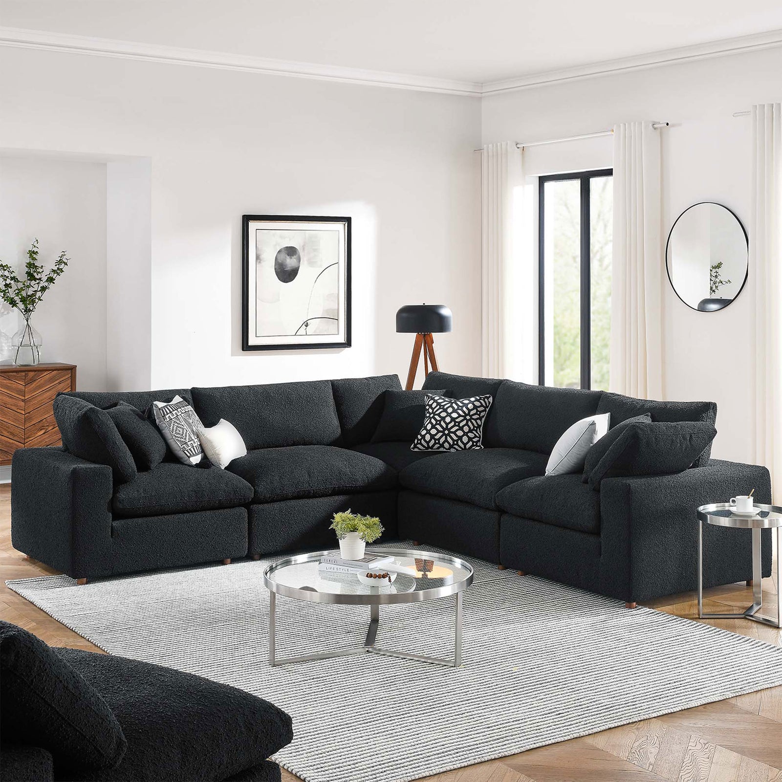 Black boucle sectional sofa styled in a bright living room with round coffee tables and contemporary decor || EEI-6368-BLK || front_angle_room