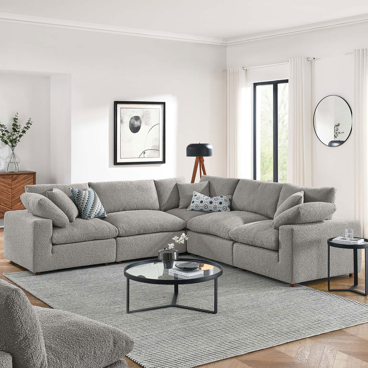 Spacious light gray boucle sectional anchored in a bright living room with modern tables and decor || EEI-6368-LGR || front_angle_room