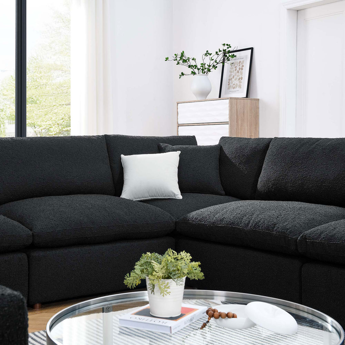 Cozy black boucle sectional corner styled with a light accent pillow in a bright modern living room || EEI-6371-BLK || detail_room