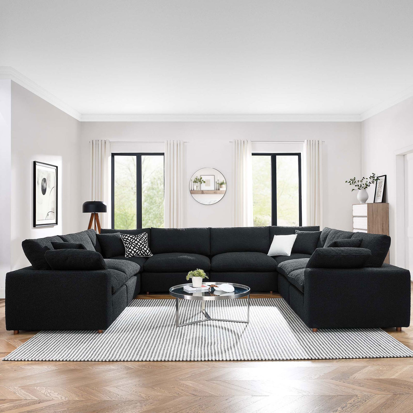 Spacious black boucle sectional sofa arranged for family lounging in an airy contemporary living room || EEI-6371-BLK || front_room