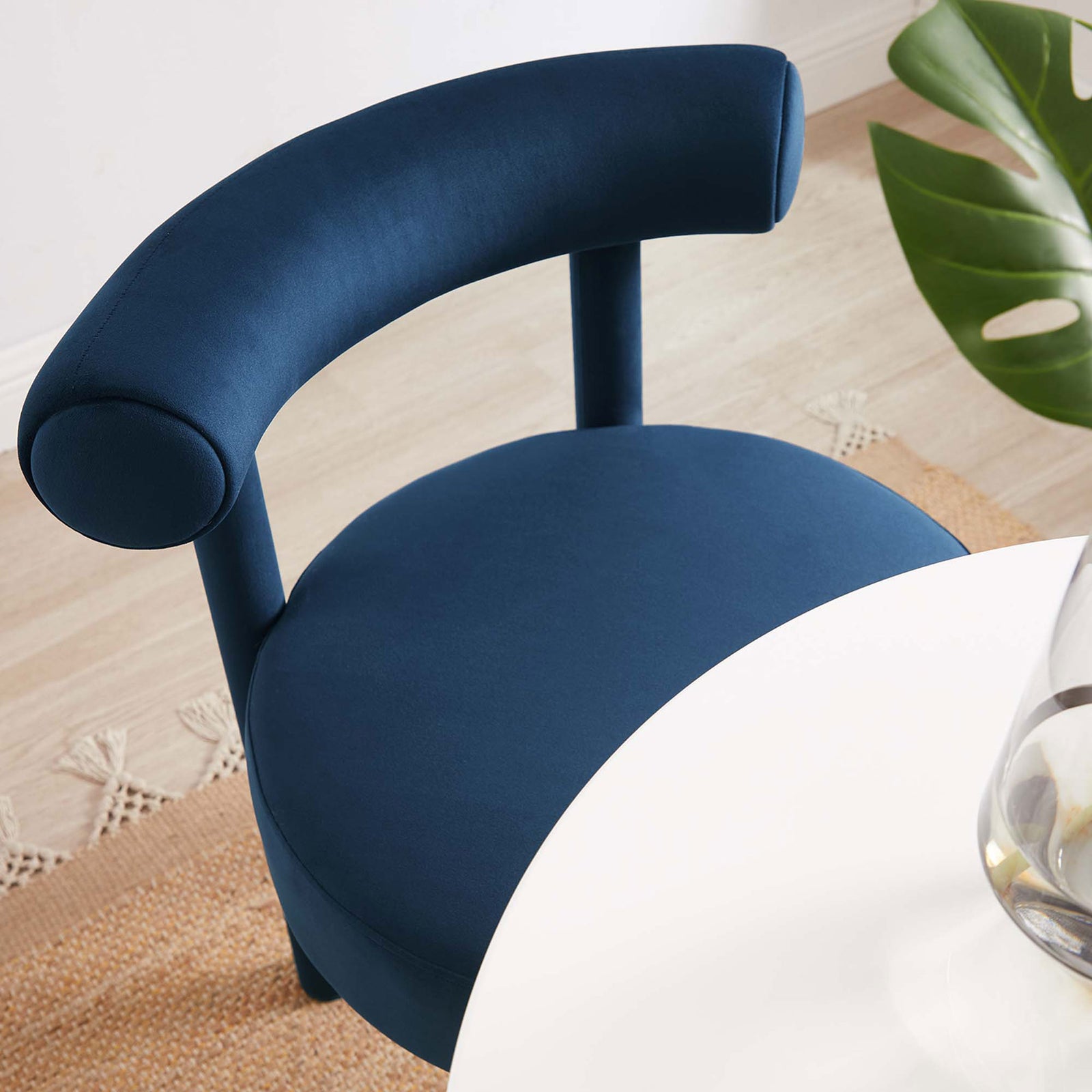 Rounded seat and curved back hug the table, creating a bright and inviting midnight blue dining nook || EEI-6388-MID || detail_room