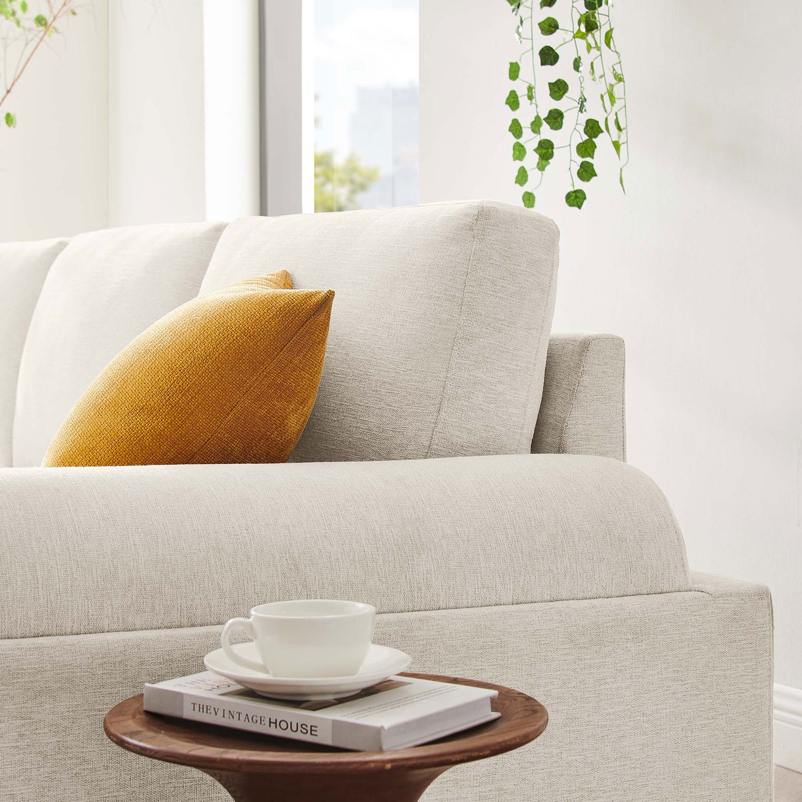 Cozy corner of the ivory Oasis sofa accented with a warm throw pillow and soft light || EEI-6401-IVO || detail_room