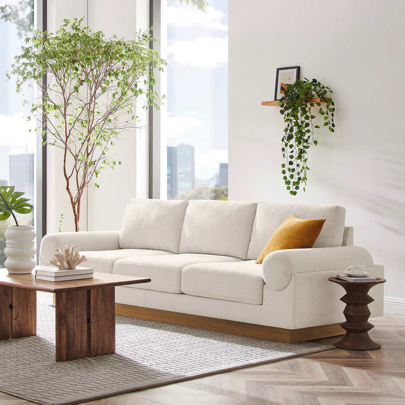 Ivory Oasis sofa on a wood base styled in a bright modern living room || EEI-6401-IVO || front_angle_room