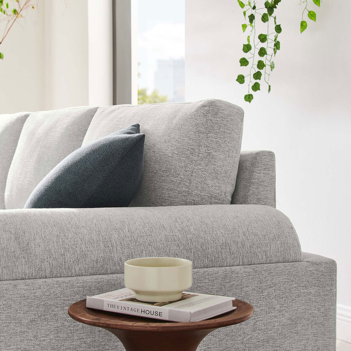 Light gray Oasis sofa styled with accent pillow in a bright, airy living space || EEI-6401-LGR || detail_room