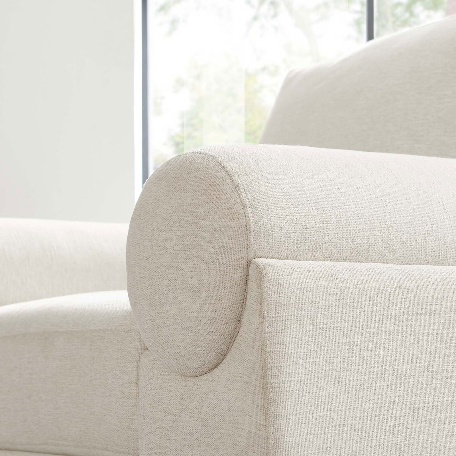 Soft ivory upholstery and rounded bolster arm with refined texture and stitching || EEI-6402-IVO || detail_room