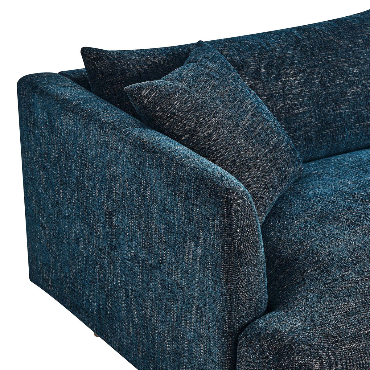 Textured navy fabric upholstery with an overstuffed pillow and softly curved arm on the Zoya sofa || EEI-6405-HEA || detail_studio