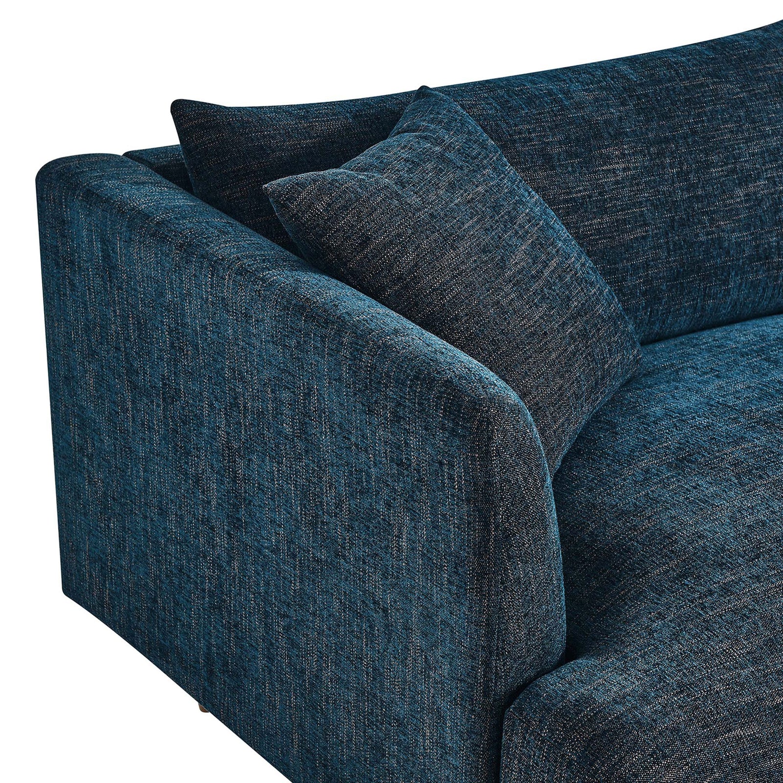 Textured navy fabric upholstery with an overstuffed pillow and softly curved arm on the Zoya sofa || EEI-6405-HEA || detail_studio