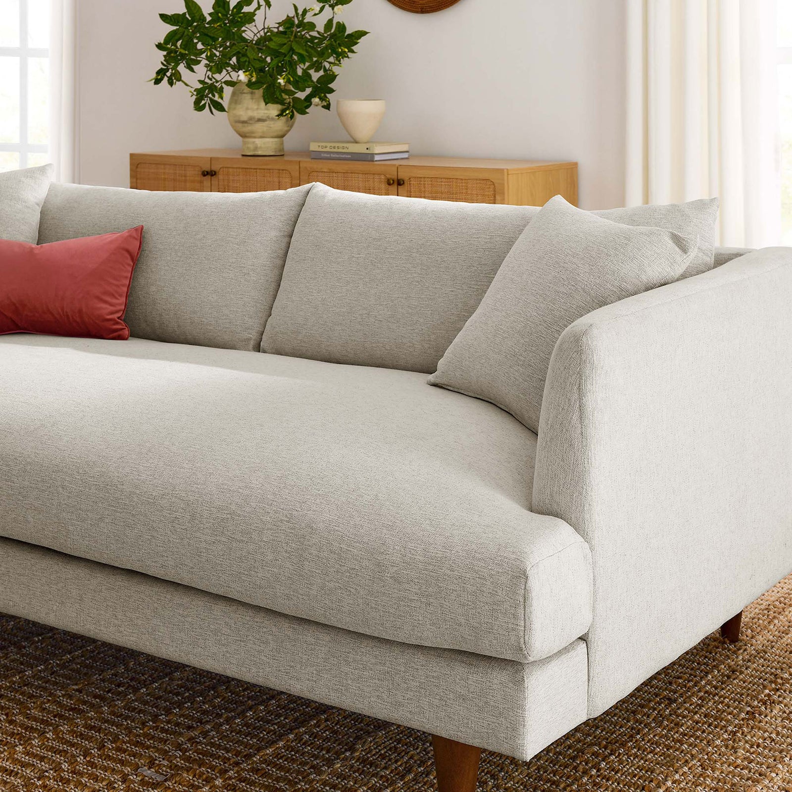 Cozy ivory cushions and deep seat create an inviting lounge spot in a warm modern living room. || EEI-6405-HEI || detail_room