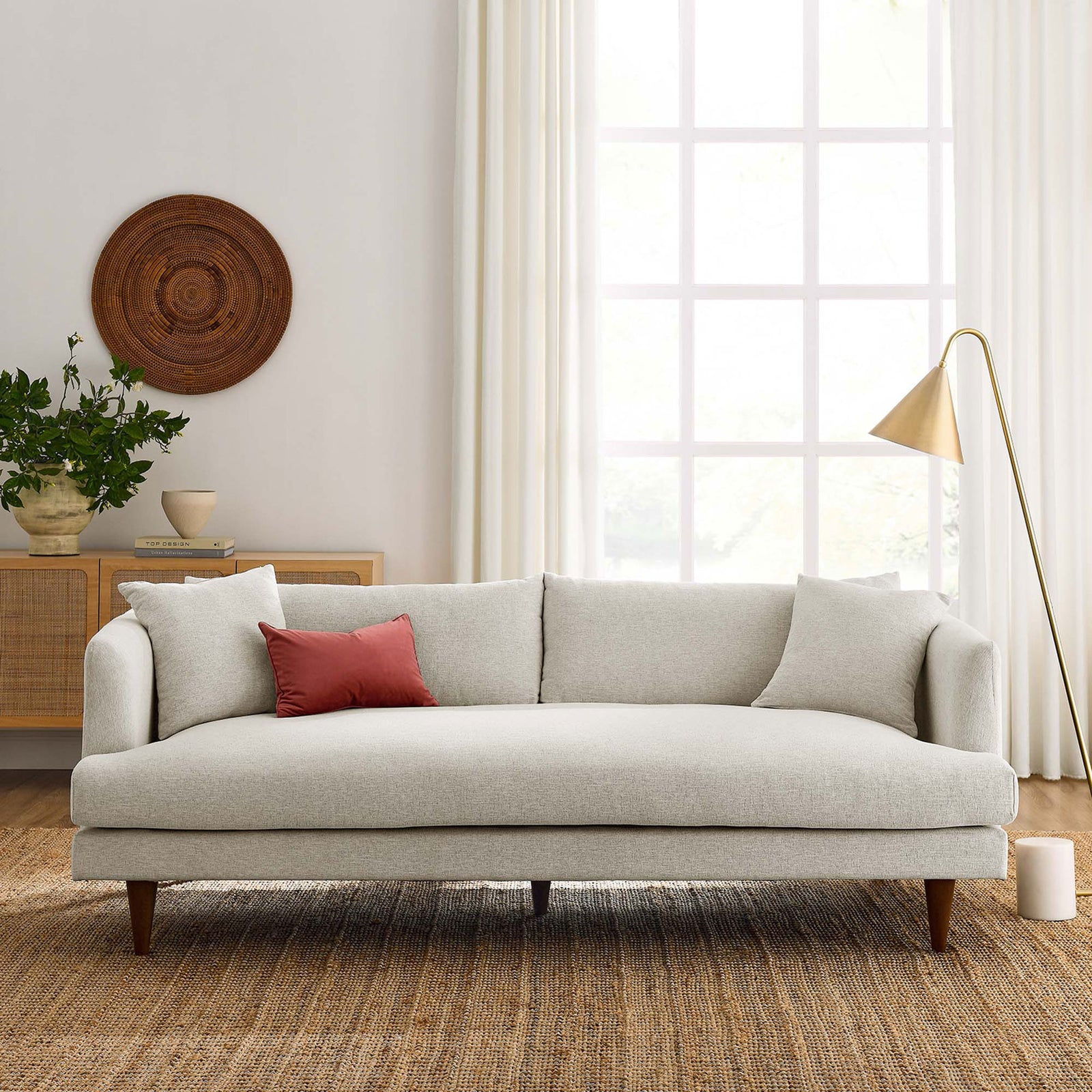 Ivory Zoya sofa anchors a bright living room with layered textures, wood accents, and brass floor lamp. || EEI-6405-HEI || front_room