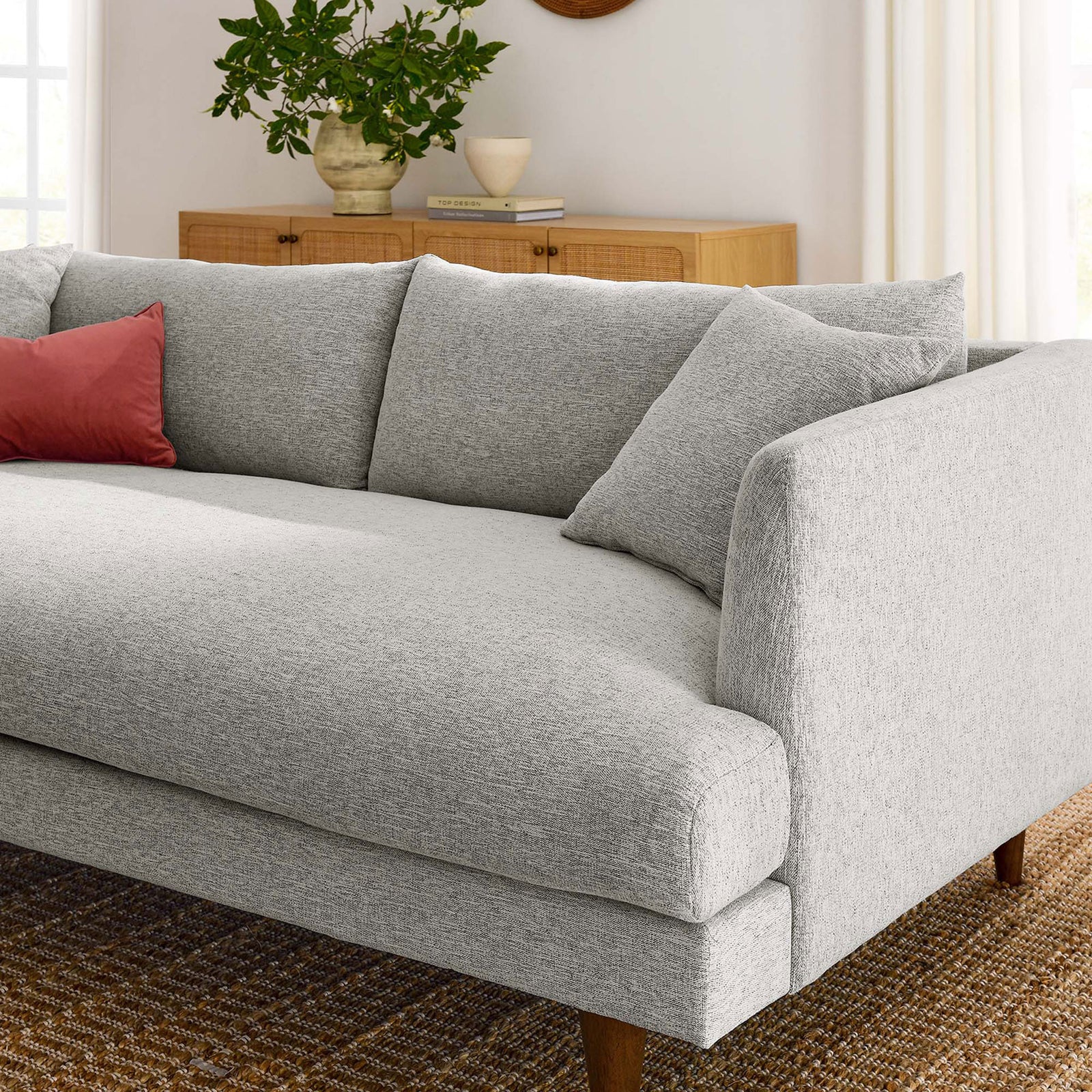 Light gray sofa styled with wood legs in a bright living room with neutral decor accents || EEI-6405-HLG || detail_room