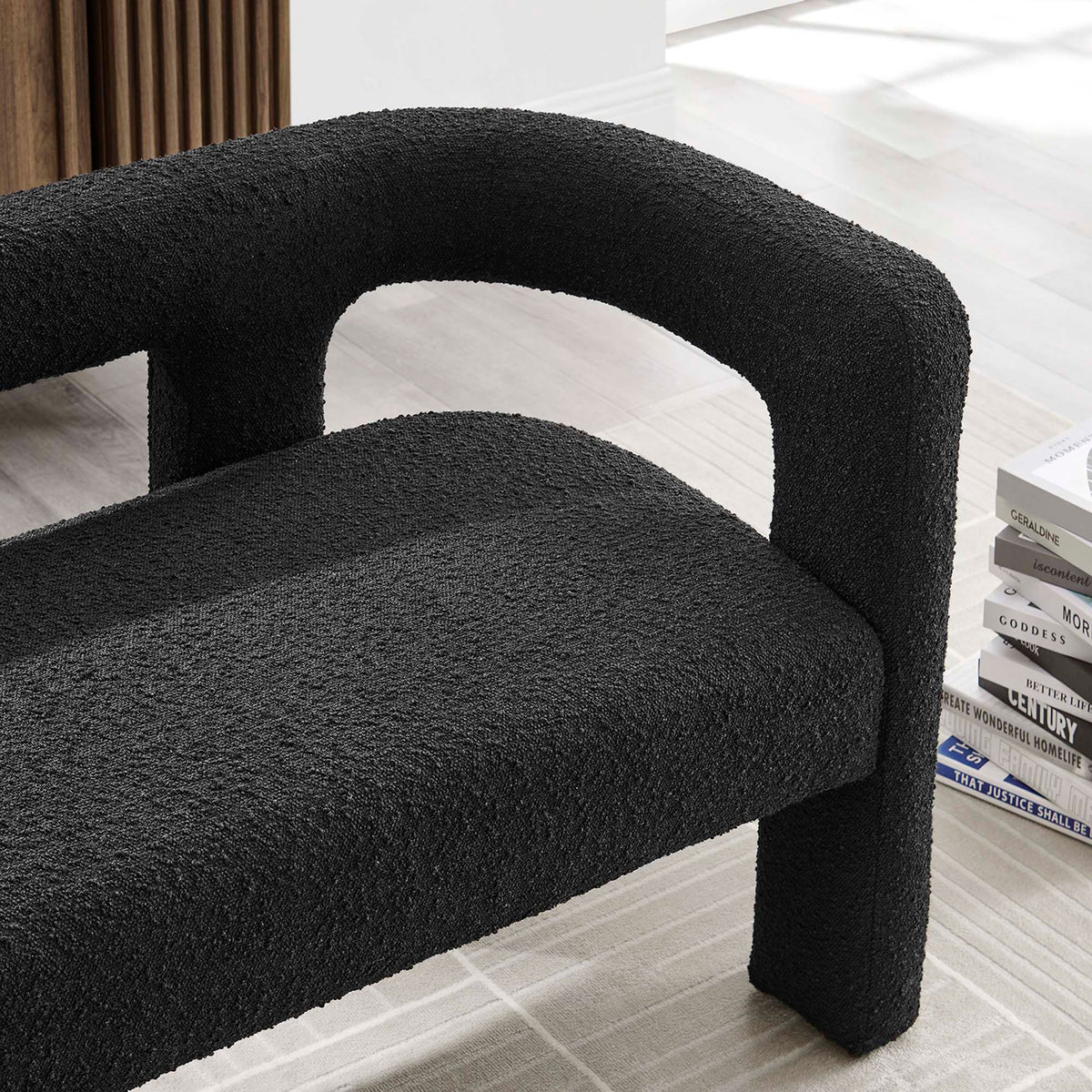 Black boucle loveseat styled in modern living room with light rug and stacked books || EEI-6477-BLK || detail_room