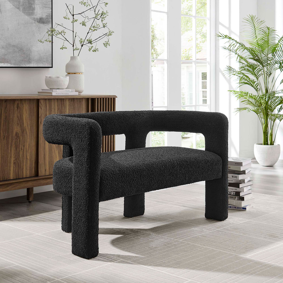 Black boucle loveseat in bright living room with wood console and greenery || EEI-6477-BLK || front_angle_room