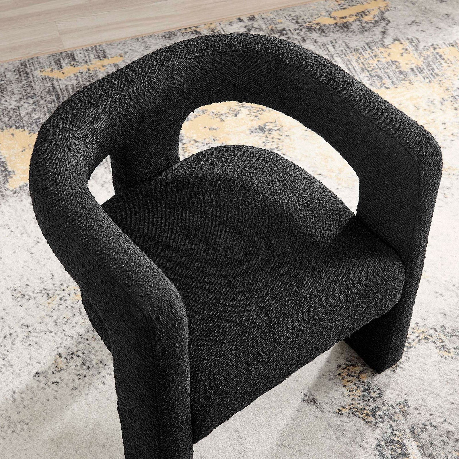Textural black boucle adds cozy contrast against a light rug for a chic, welcoming lounge spot. || EEI-6479-BLK || top_room