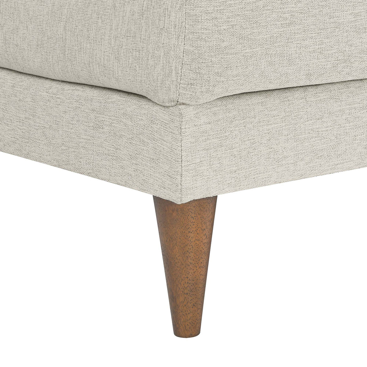 Neatly tailored ottoman corner featuring textured ivory fabric and tapered wood legs with a warm finish || EEI-6481-HEI || leg_studio