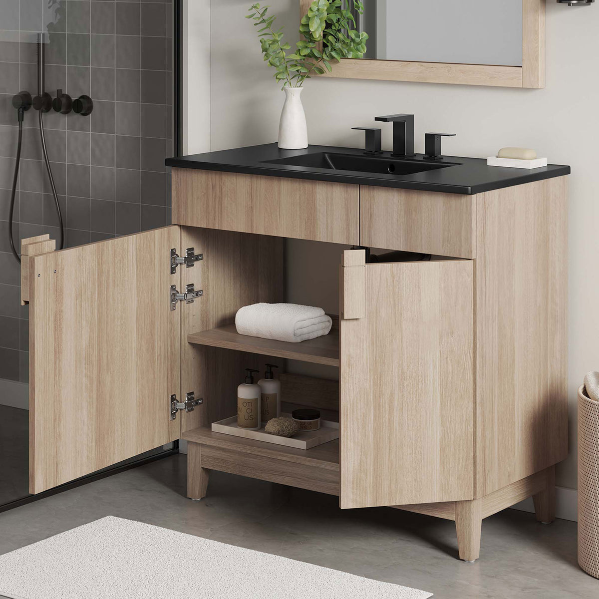 Open doors display roomy shelves for towels and toiletries, plus a plumbing cutout for easy access. || EEI-6485-BLK-OAK || front_angle_open_room