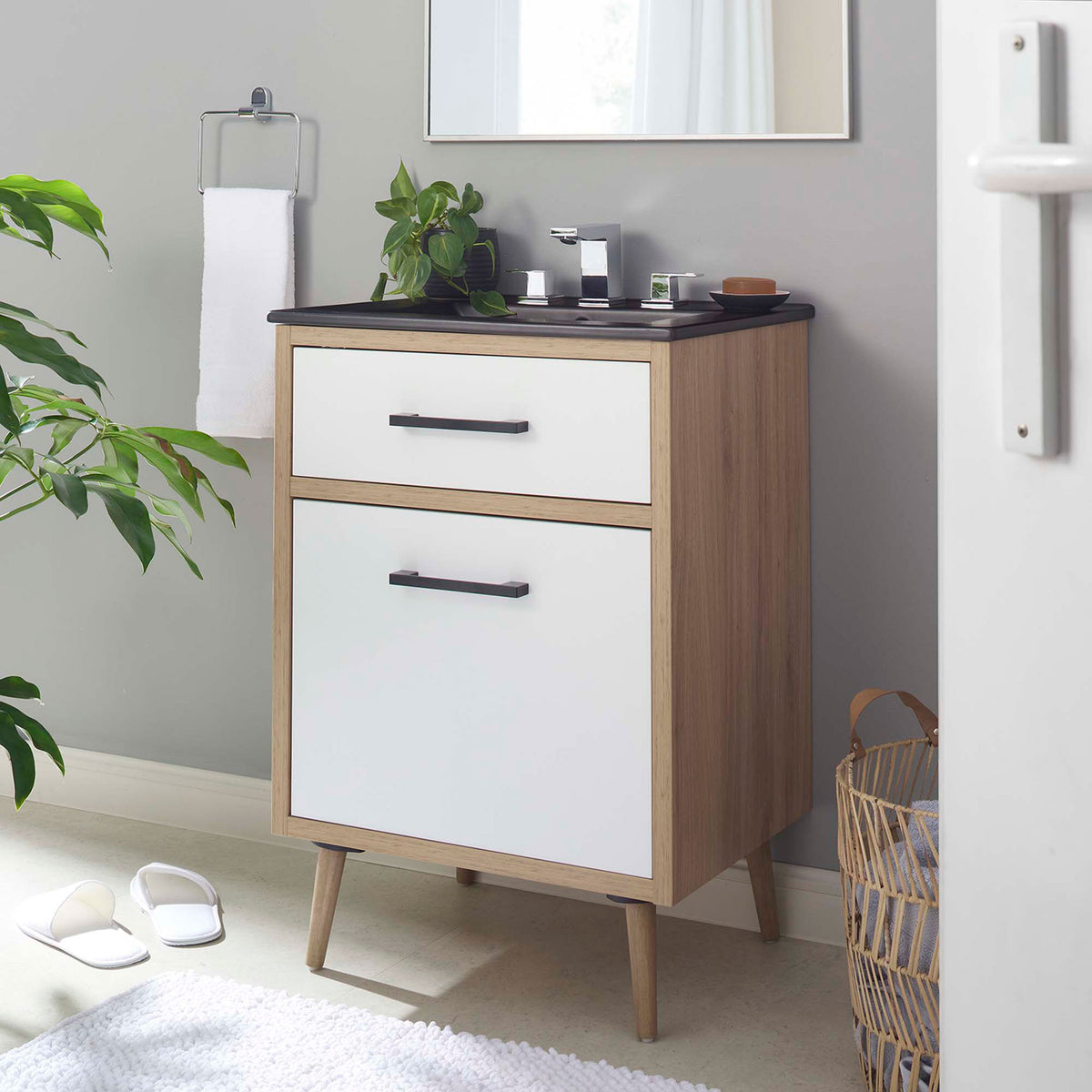 Stylish 24 inch vanity elevates the bathroom with black top, white drawers, and oak body || EEI-6499-BLK-OAK || front_angle_room