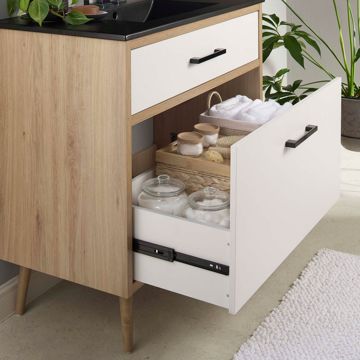 Extra-wide bottom drawer neatly stores bath essentials for clutter-free living || EEI-6501-BLK-OAK || storage_open_room