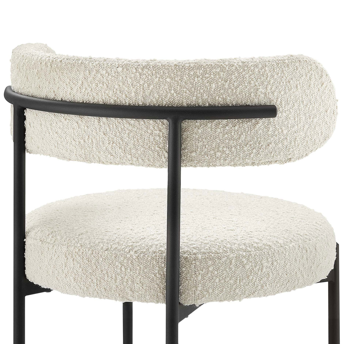 Textured ivory boucle upholstery and curved backrest supported by a slim black rail. || EEI-6516-IVO-BLK || detail_studio