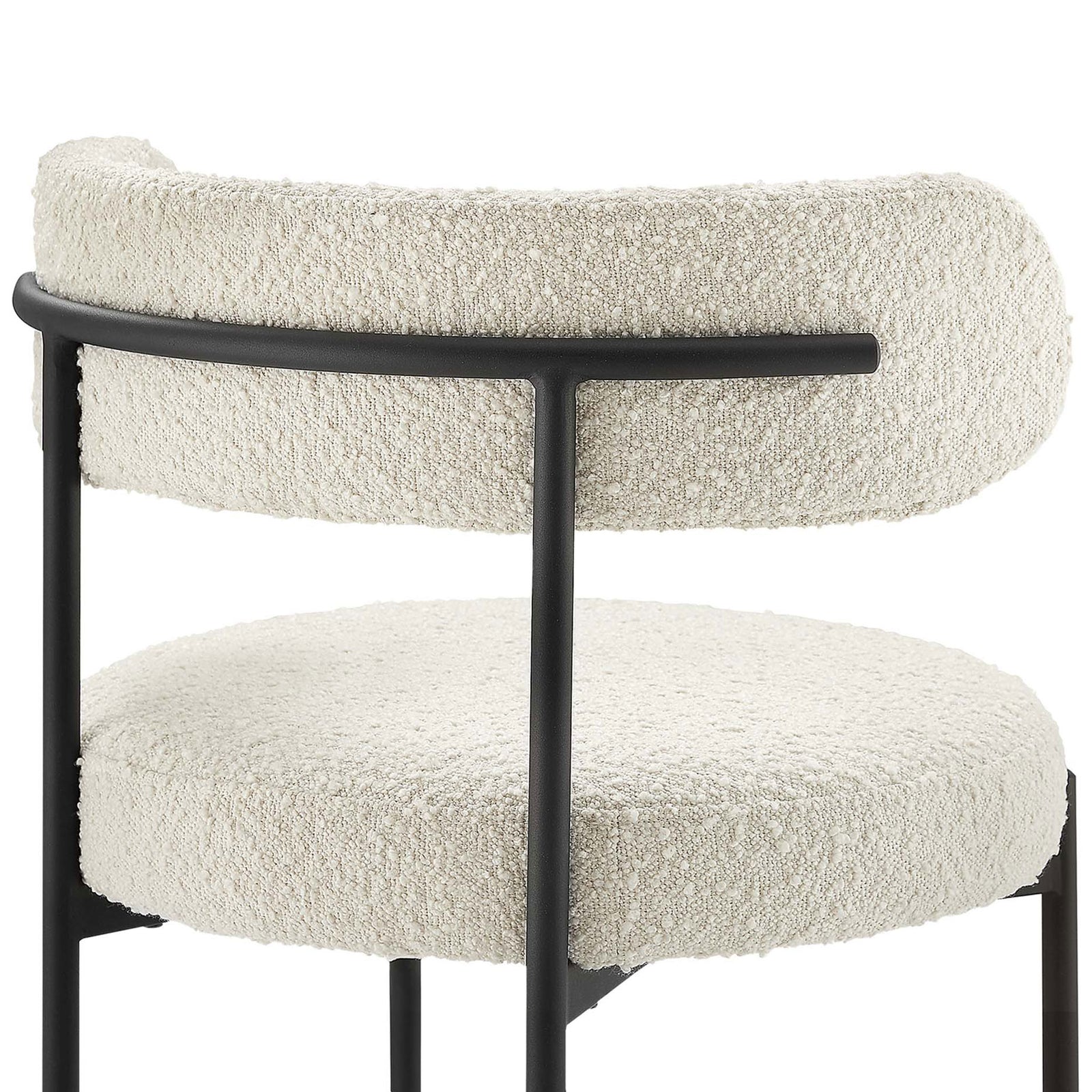 Textured ivory boucle upholstery and curved backrest supported by a slim black rail. || EEI-6516-IVO-BLK || detail_studio