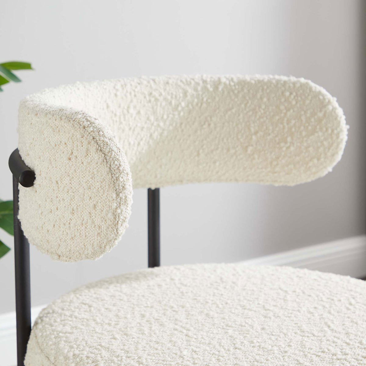 Plush ivory boucle backrest and inviting texture of the dining chair in a bright room setting. || EEI-6516-IVO-BLK || detail_room