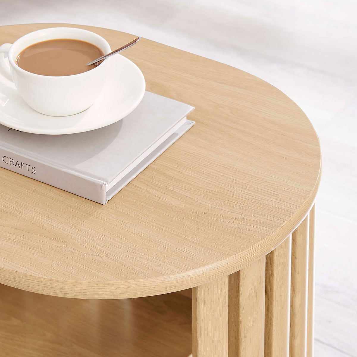 Oak side table top styled with a cup of coffee and book to showcase its smooth wood grain surface || EEI-6523-OAK || detail_room