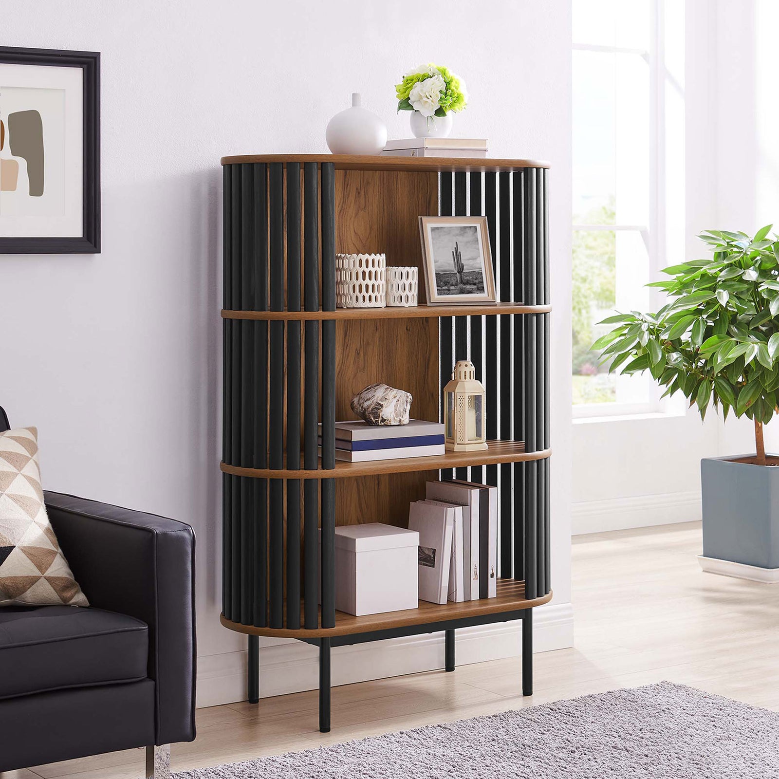 Three-tier walnut display cabinet brings warm texture and open storage to a bright, contemporary living space || EEI-6524-WAL-BLK || front_angle_room