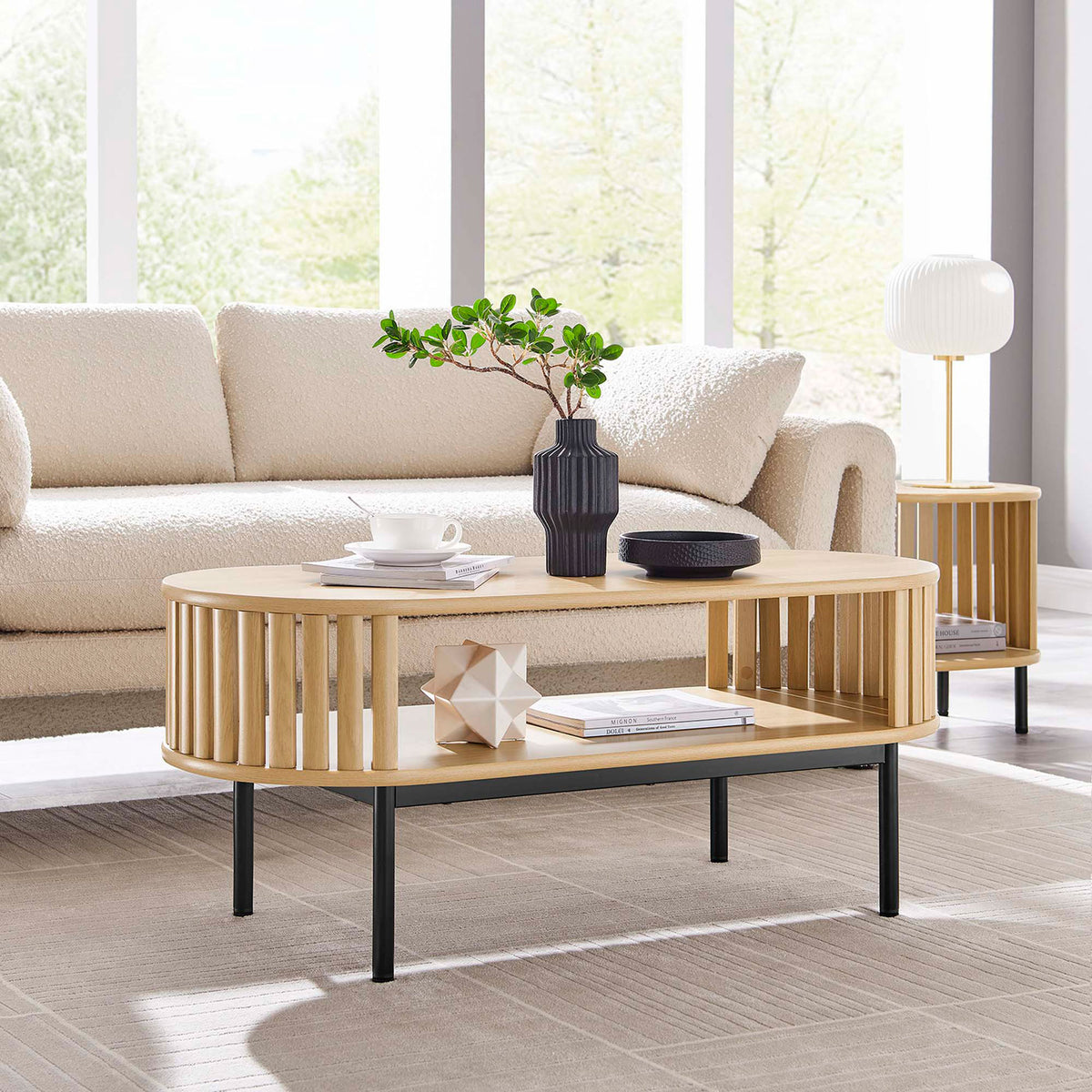 Modern oak coffee table anchors the space with open shelving and slender black legs || EEI-6525-OAK || front_angle_room