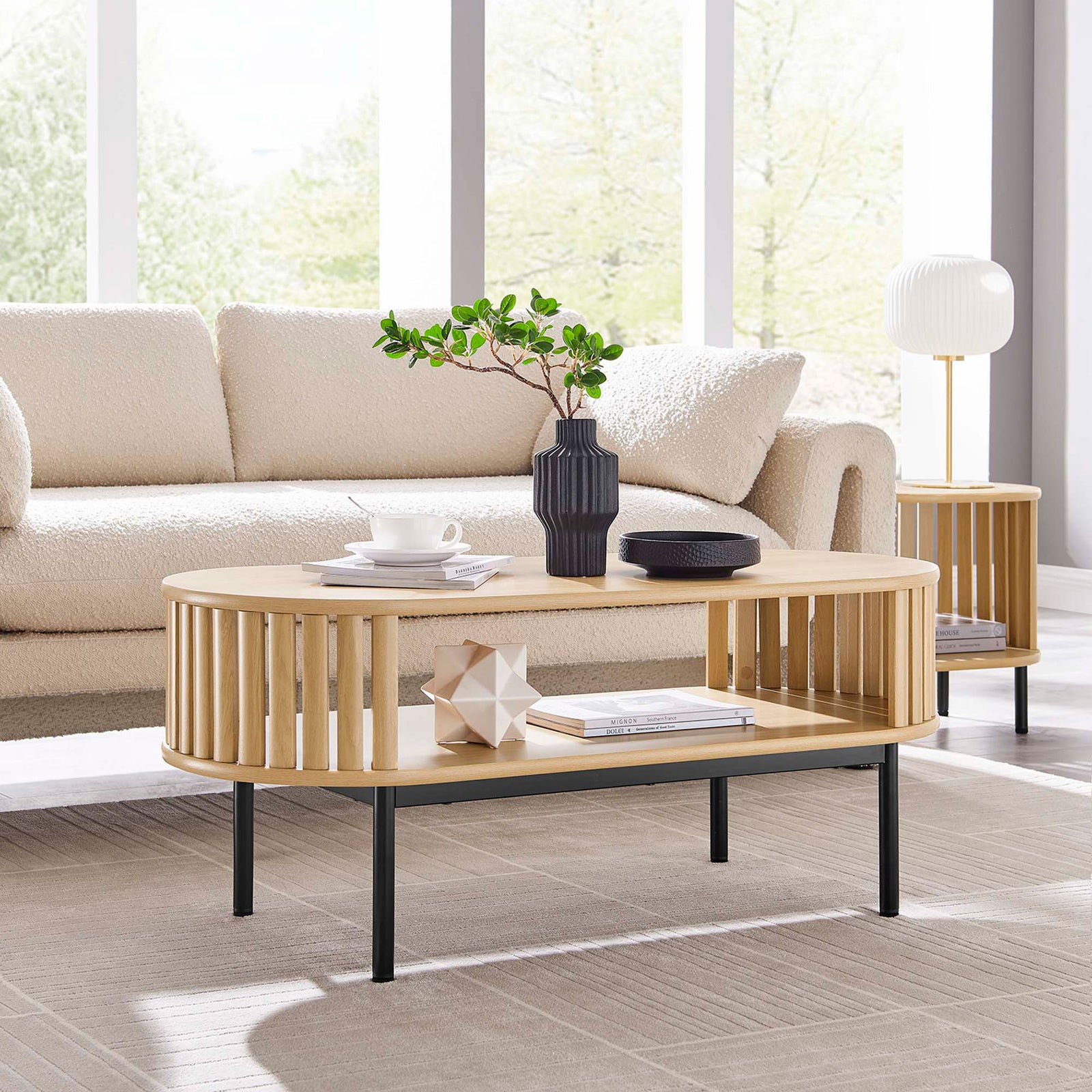 Modern oak coffee table anchors the space with open shelving and slender black legs || EEI-6525-OAK || front_angle_room