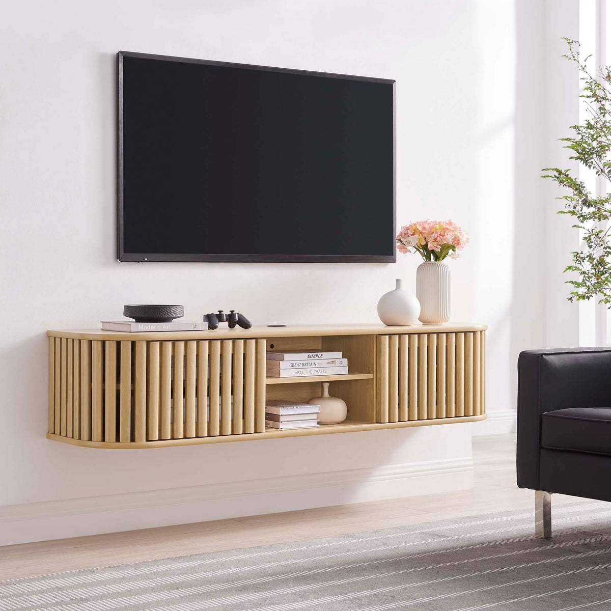 Oak Fortitude wall mounted TV stand floating beneath a large screen to streamline a contemporary living space || EEI-6528-OAK || front_room