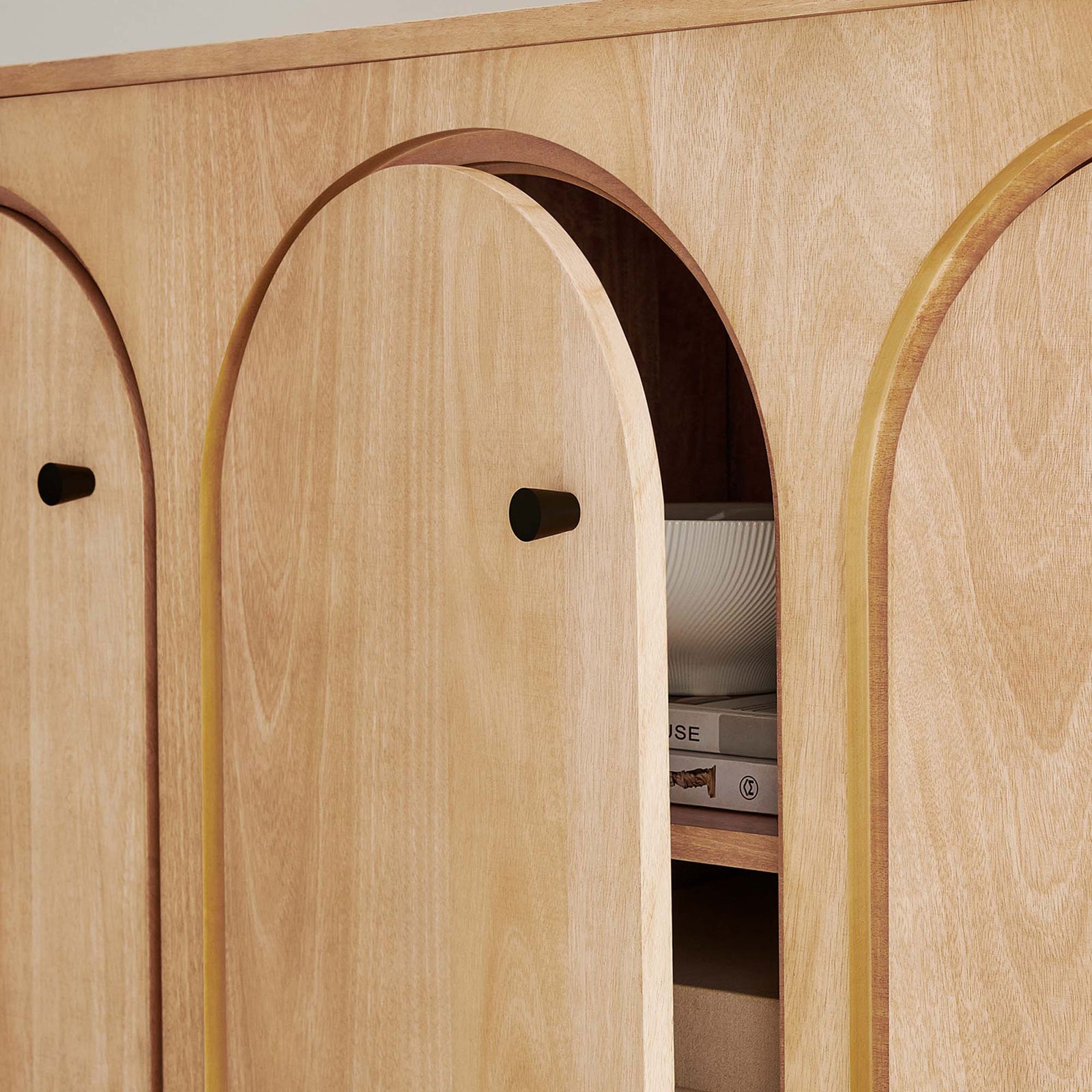 Interior storage of the oak cabinet with arched door partially open to display neatly arranged decor || EEI-6536-OAK || storage_open_room