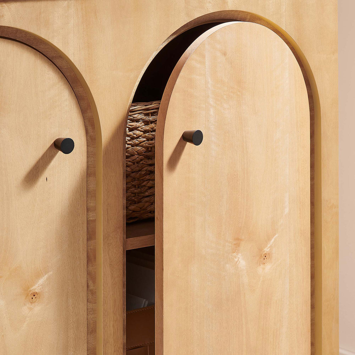 Partially open oak doors reveal generous cabinet storage for baskets and boxes || EEI-6537-OAK || storage_open_room
