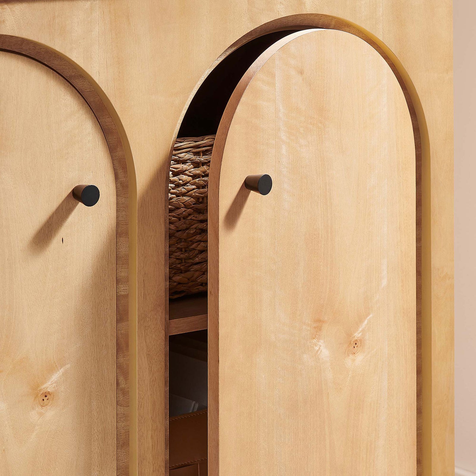 Partially open oak doors reveal generous cabinet storage for baskets and boxes || EEI-6537-OAK || storage_open_room