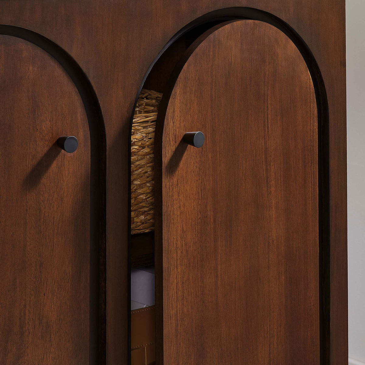 Partially open walnut doors reveal generous cabinet storage for baskets and boxes || EEI-6537-WAL || storage_open_room