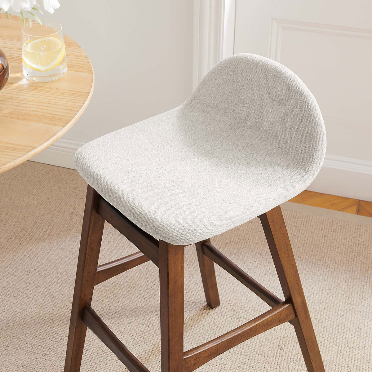Ivory seat and curved back add soft contrast beside a round table in a cozy room || EEI-6553-HEI || detail_room