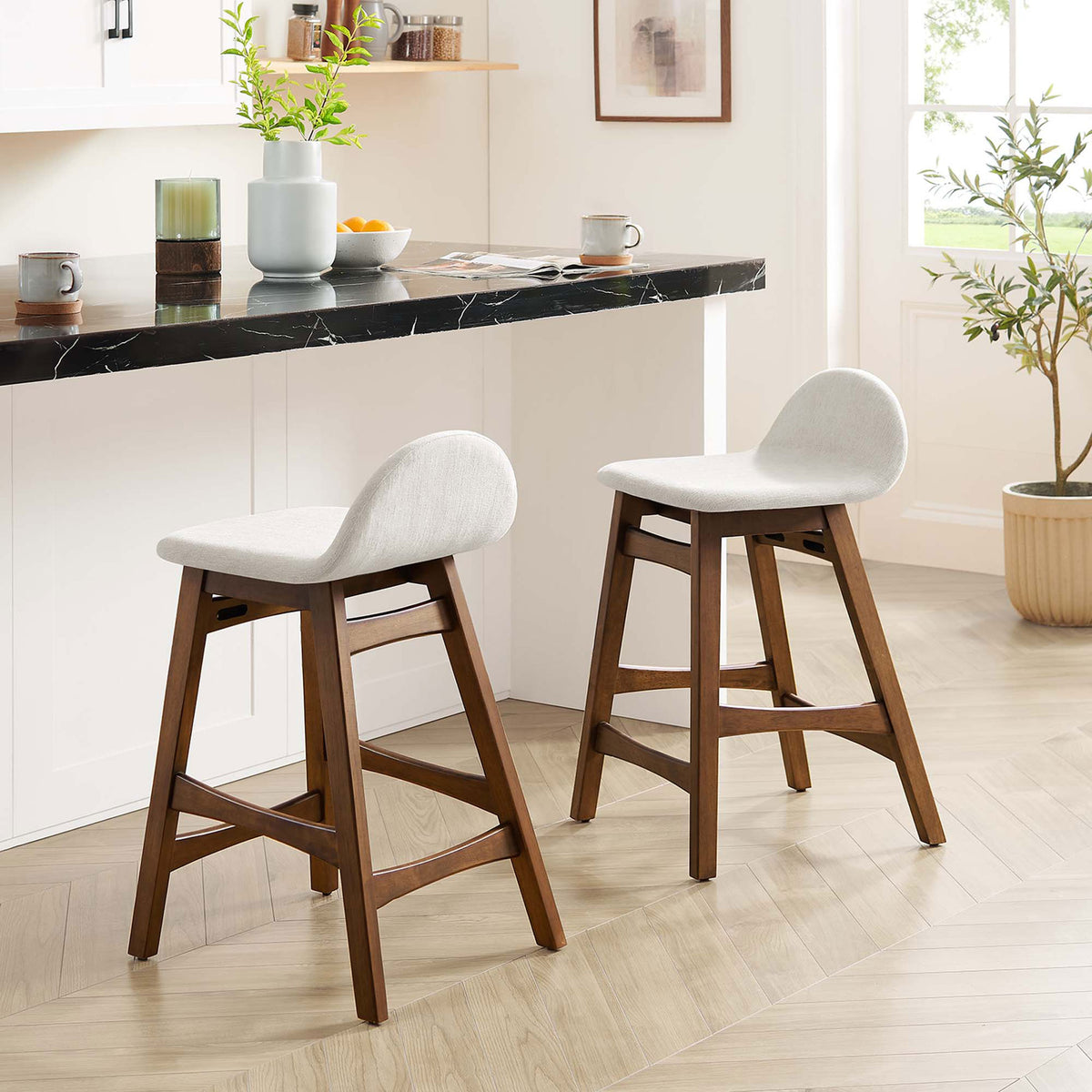 Pair of counter stools elevating a bright kitchen with warm wood and soft ivory seats || EEI-6555-HEI || front_angle_multi_room