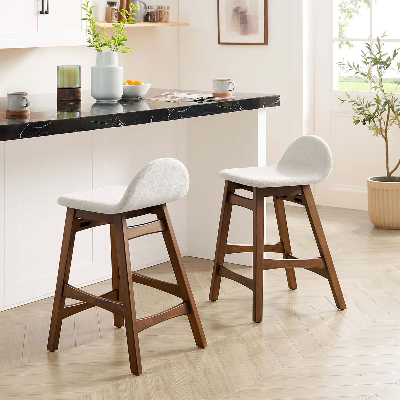 Pair of counter stools elevating a bright kitchen with warm wood and soft ivory seats || EEI-6555-HEI || front_angle_multi_room