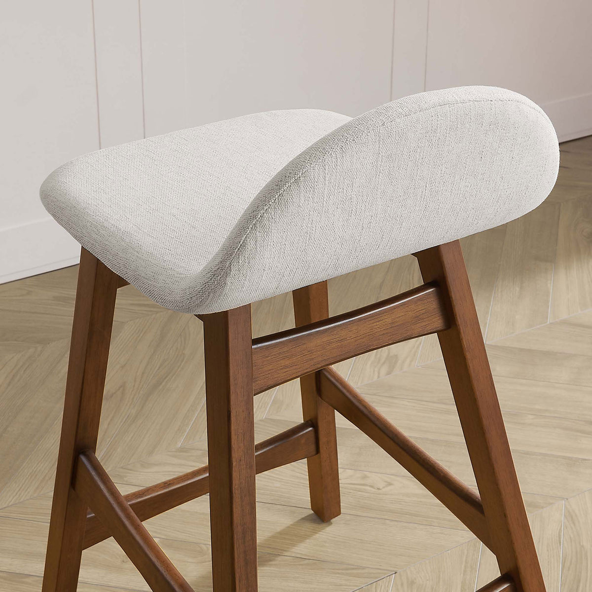 Textured ivory seat and gentle curve complementing the wood base in a modern kitchen || EEI-6555-HEI || detail_room