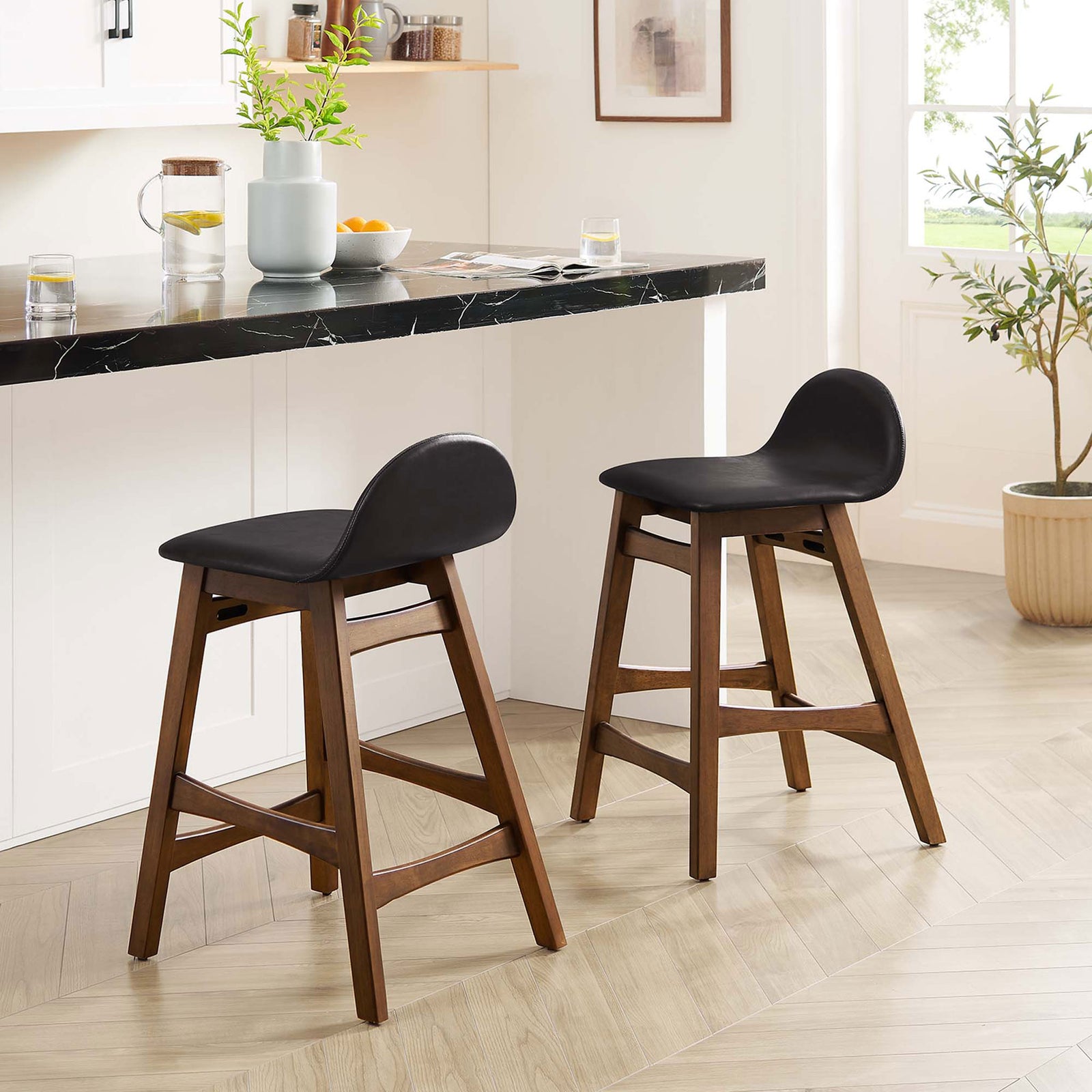 Two counter stools bring mid-century warmth to the kitchen with vegan leather seats and wood frames || EEI-6556-BRN || front_angle_multi_room