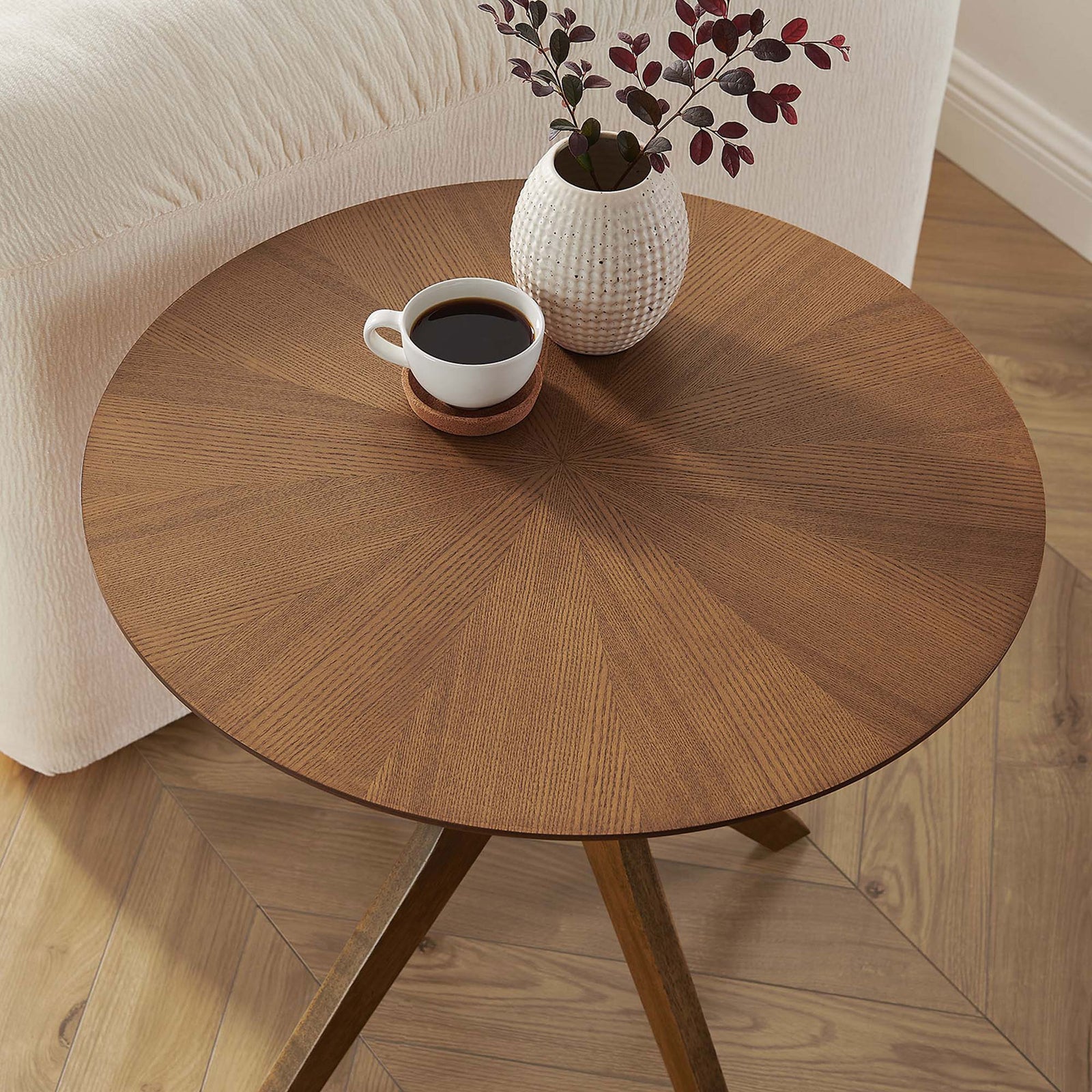 Walnut round side table styled with coffee and decor beside a neutral sofa in a bright room || EEI-6558-WAL || top_angle_room