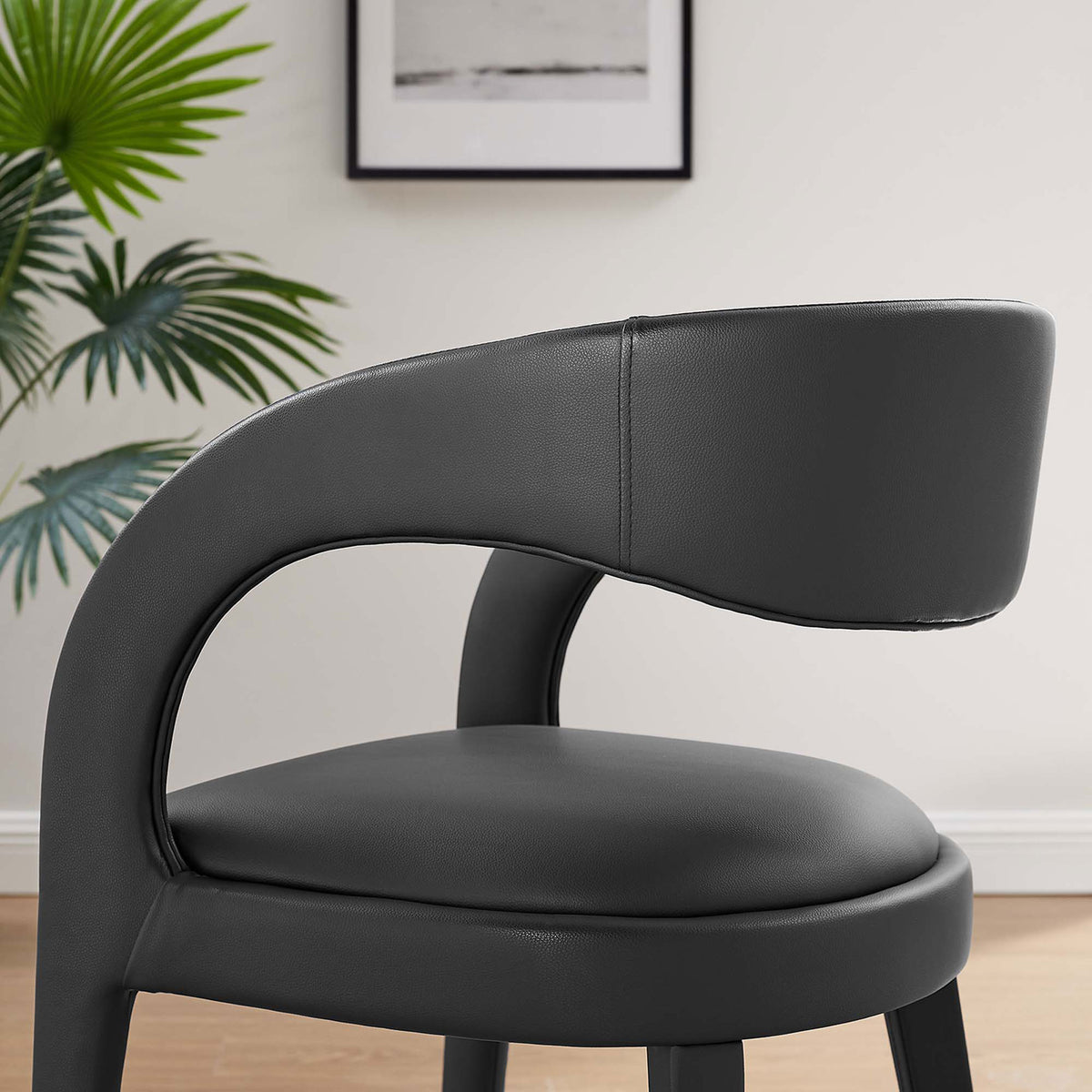 Room closeup of black vegan leather chair showing curved backrest and soft padding || EEI-6561-BLK || detail_room