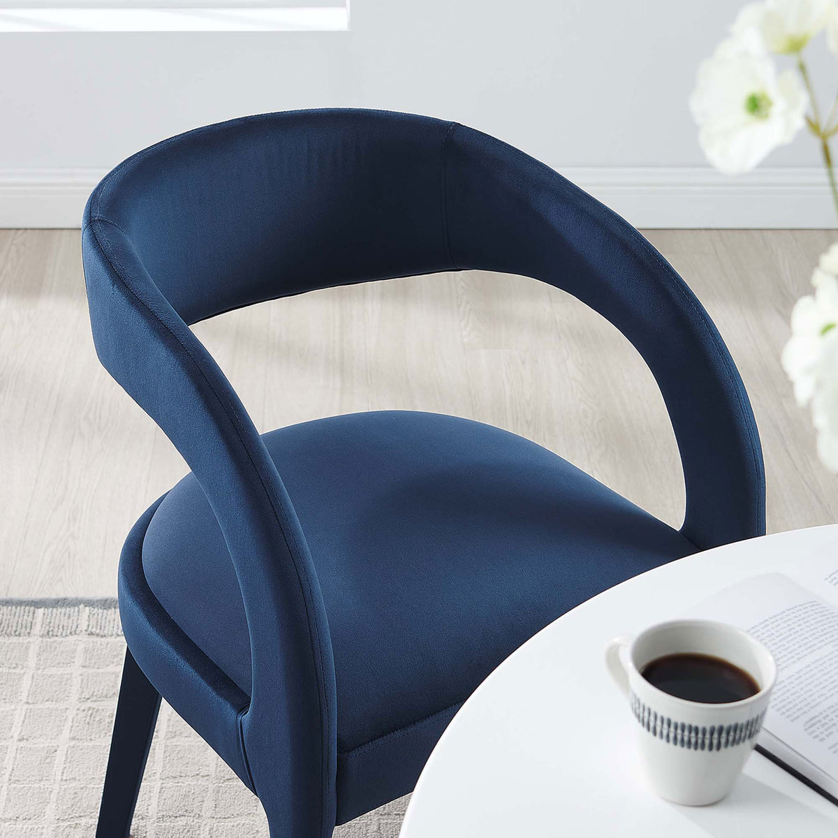 Midnight blue velvet dining chair paired with a round white table to create a cozy modern breakfast nook || EEI-6563-MID || detail_room