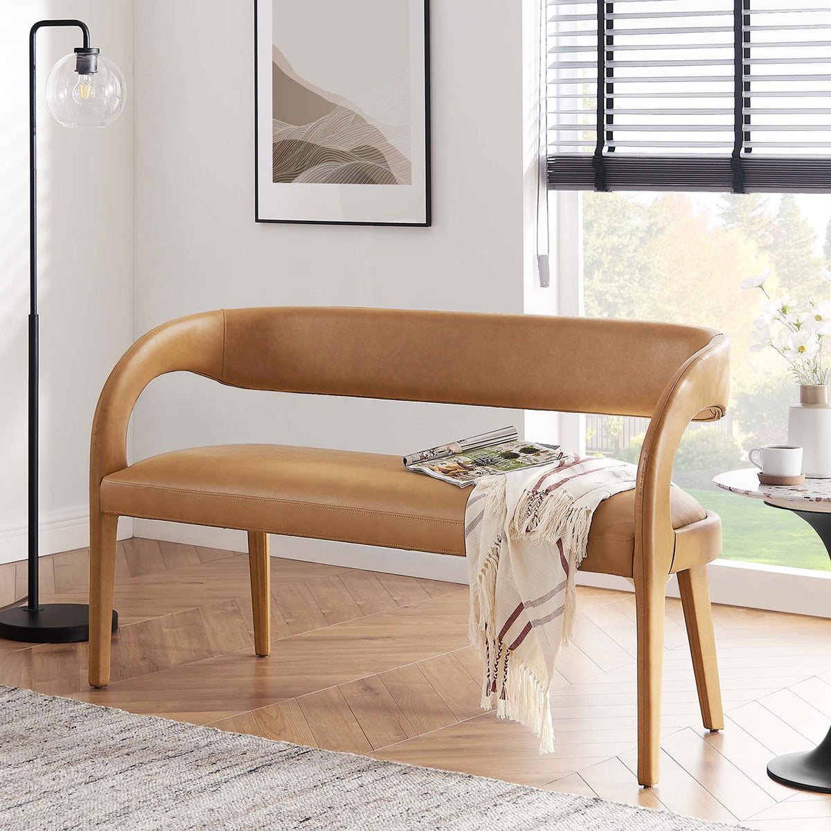 Modern tan bench elevates living spaces with sculptural curves and cushioned comfort || EEI-6570-TAN || front_angle_room