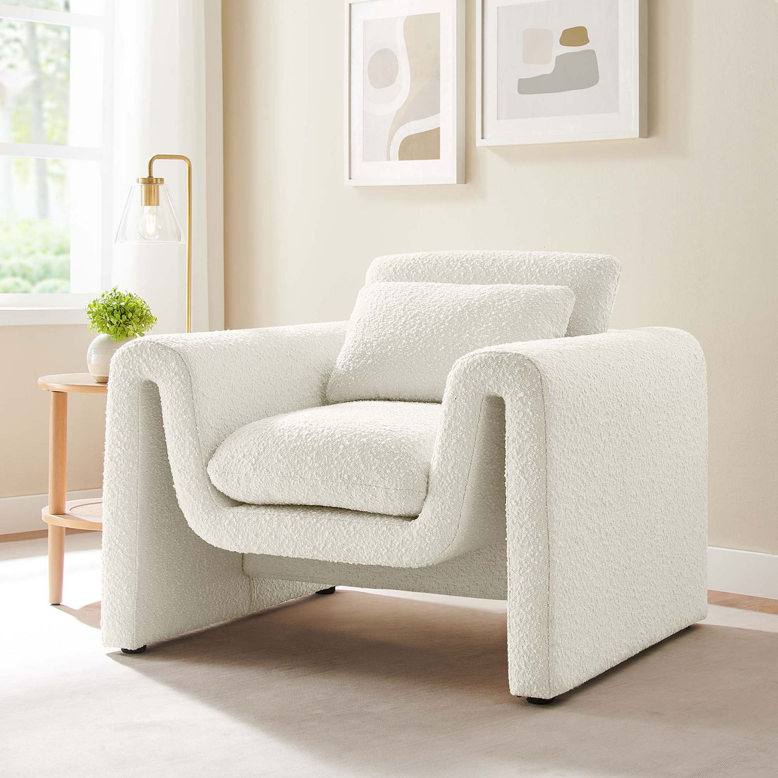 Stylish ivory boucle armchair elevates living spaces with its bold curves and cloudlike comfort. || EEI-6575-IVO || front_angle_room