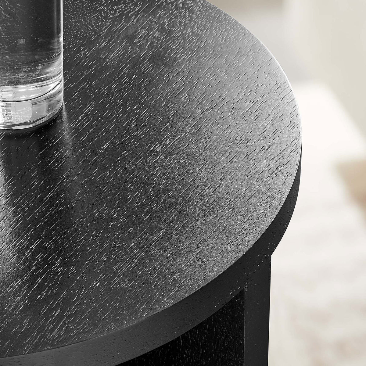 Black mango wood tabletop styled with a clear glass, showcasing the smooth finish in a bright living room || EEI-6579-BLK || detail_room