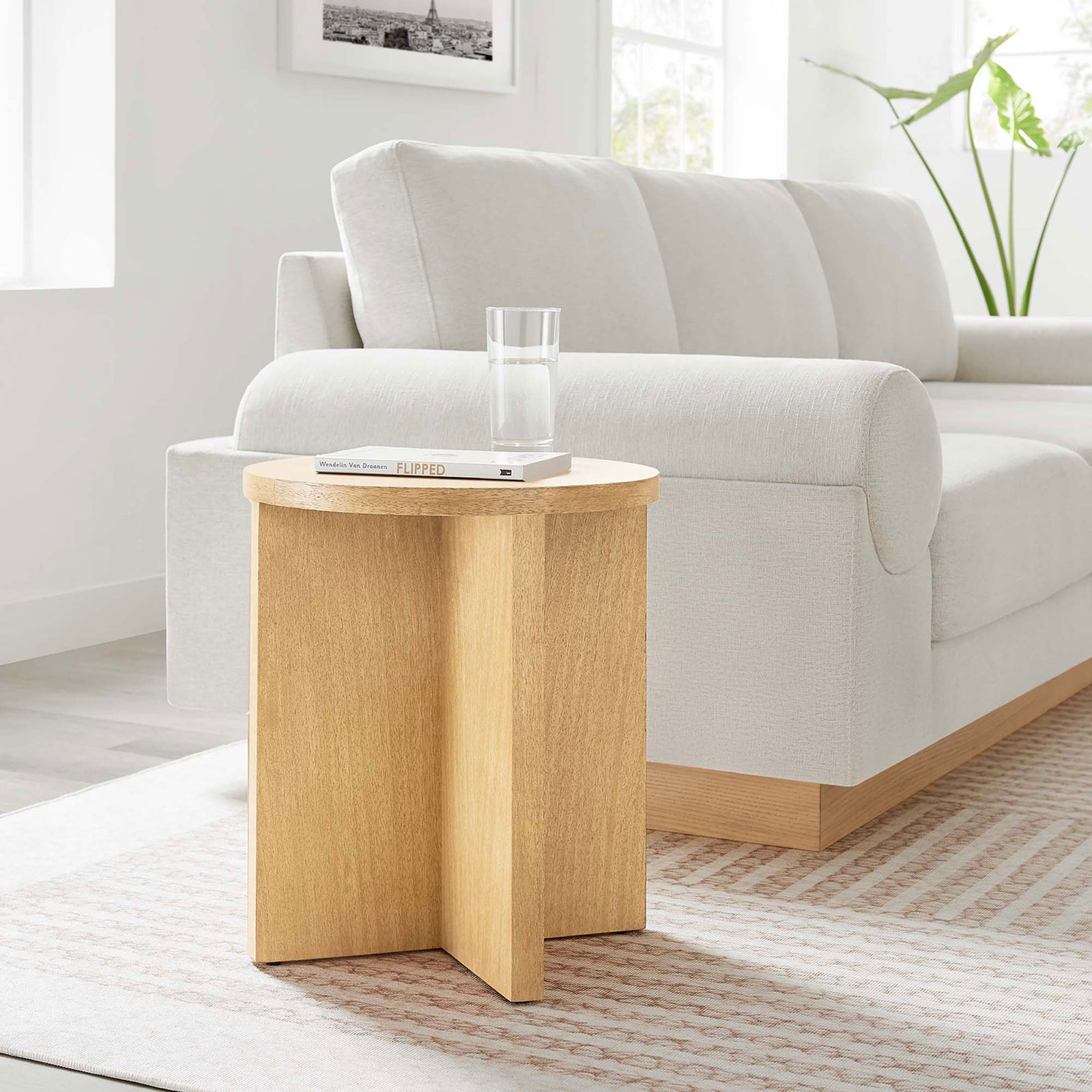 Natural wood round side table styled beside a modern cream sofa || EEI-6579-NAT || front_angle_room