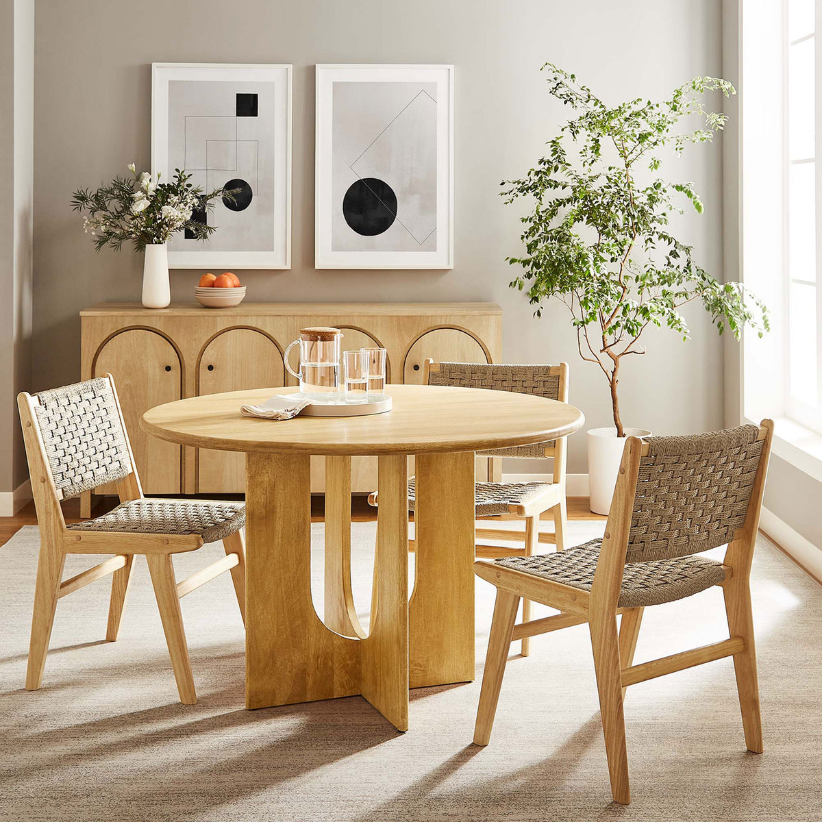 Oak round dining table anchoring a bright modern dining room with coordinating chairs and warm wood accents || EEI-6592-OAK || front_angle_room